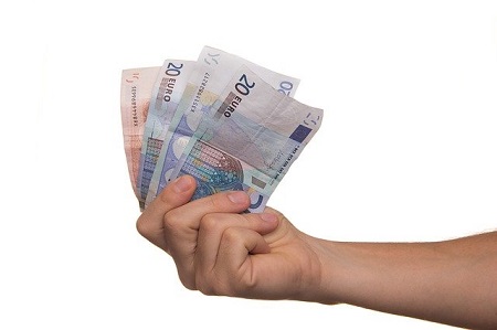 mano con billetes ofreciendo ayuda economica